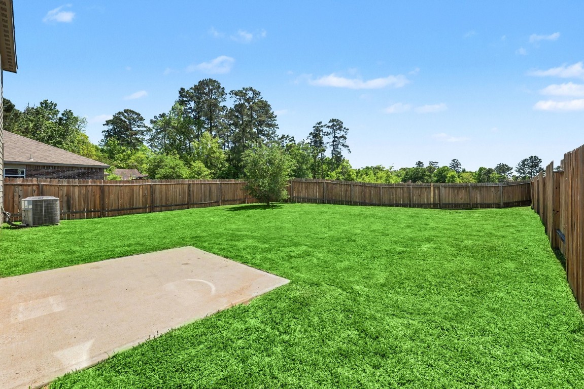 7722 Boulder Sunstone Lane Conroe, TX 77304 - Photo 23 of 25 a view of yard with green space