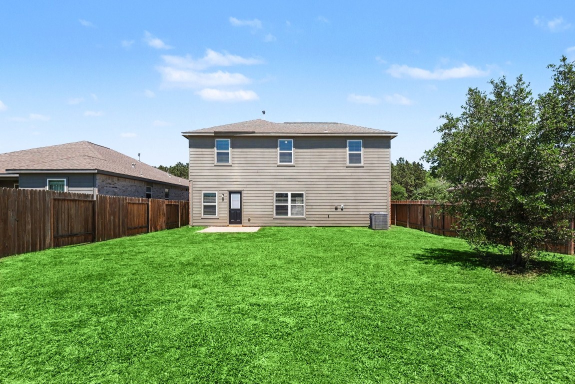 7722 Boulder Sunstone Lane Conroe, TX 77304 - Photo 24 of 25 a view of a back yard of the house