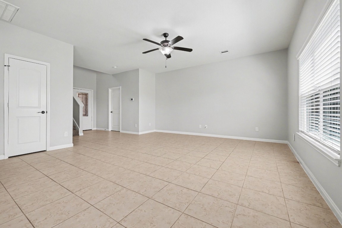 7722 Boulder Sunstone Lane Conroe, TX 77304 - Photo 6 of 25 a view of a livingroom with a ceiling fan and window