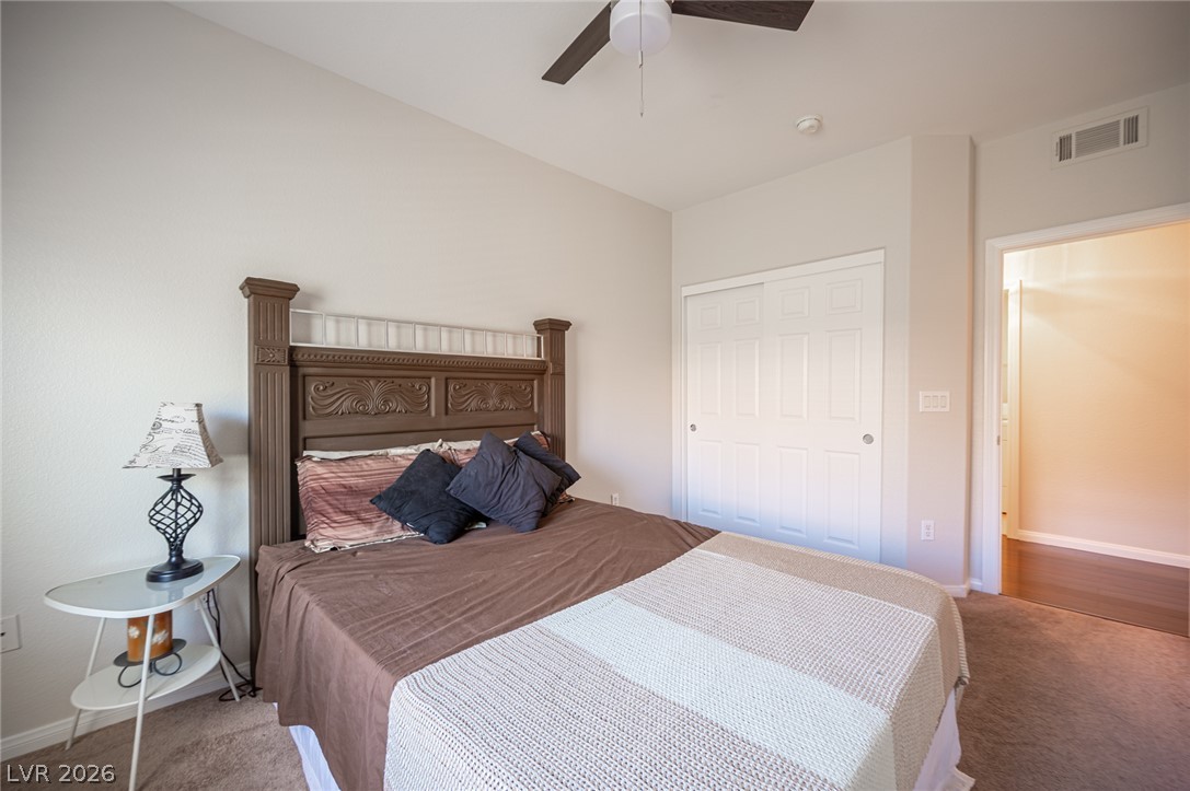 7701 West Robindale Road, Unit 274 Las Vegas, NV 89113 - Photo 26 of 43 A well-appointed bedroom features a carved headboard and convenient sliding closet doors.