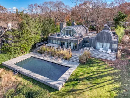 an aerial view of a house with swimming pool garden and patio