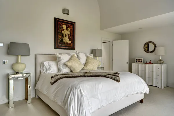 a bedroom with a bed and a lamp
