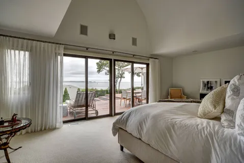 a spacious bedroom with a bed and a large window