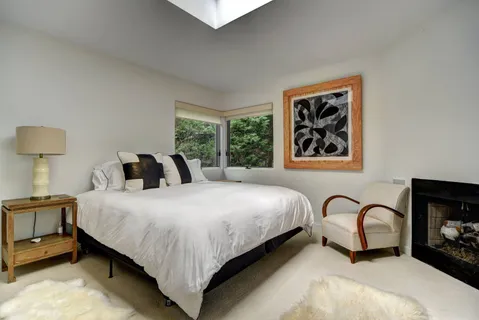 a bedroom with bed and a window