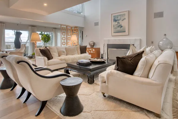 a living room with furniture and a potted plant