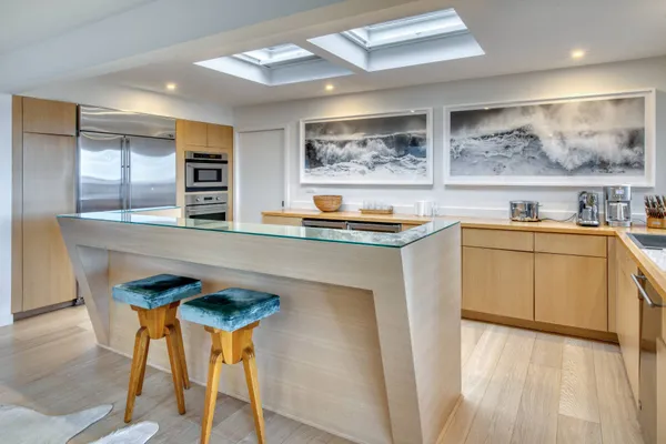 a kitchen with stainless steel appliances kitchen island granite countertop a sink and cabinets