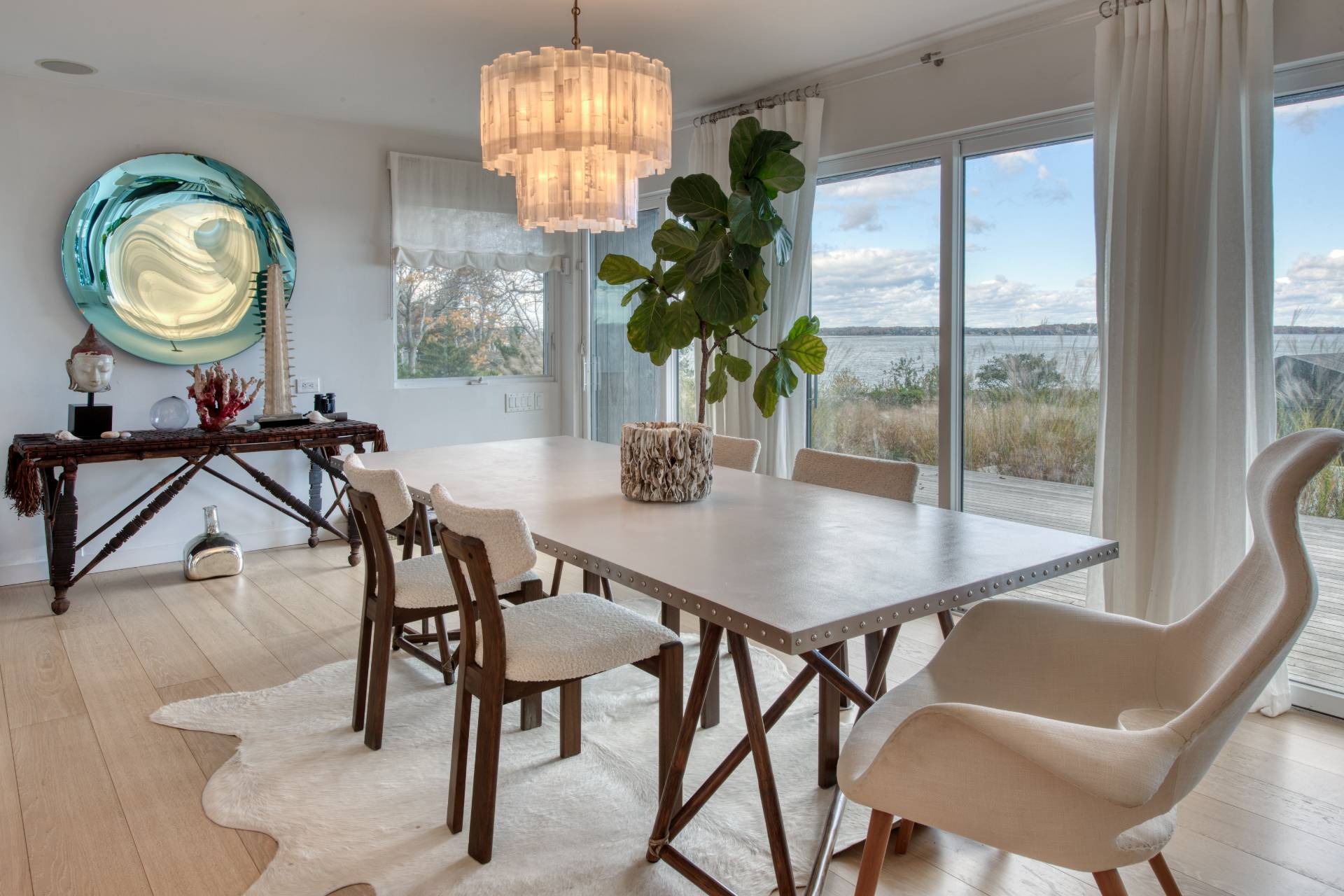 18 Sound View Drive Sag Harbor, NY 11963 - Photo 8 of 28 a view of a dining room with furniture a chandelier and wooden floor