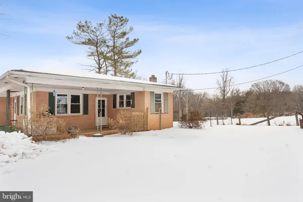 a view of a house with a snow in the yard