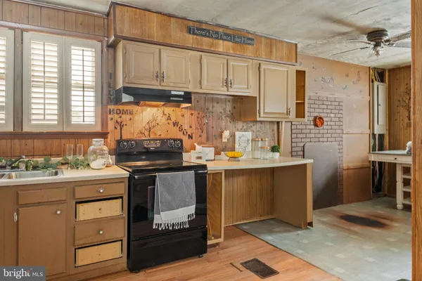 a kitchen with a sink cabinets and window