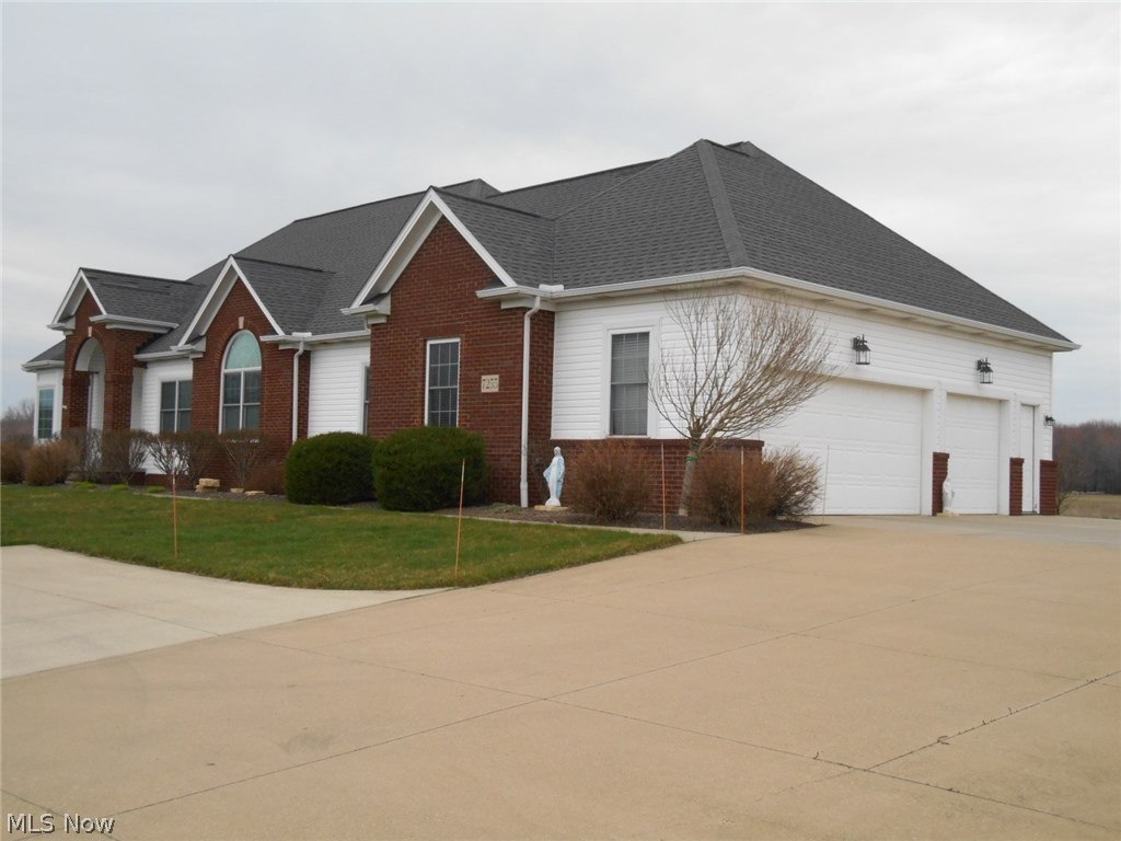 7255 Dewey Road Thompson, OH 44086 - Photo 2 of 35 South side of home, showing garages and concrete drive