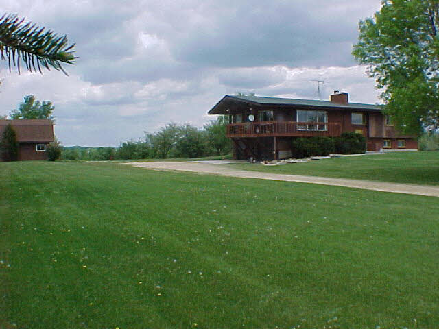11311 Smith Road Pecatonica, IL 61063 - Photo 2 of 5 a front view of house with yard and green space