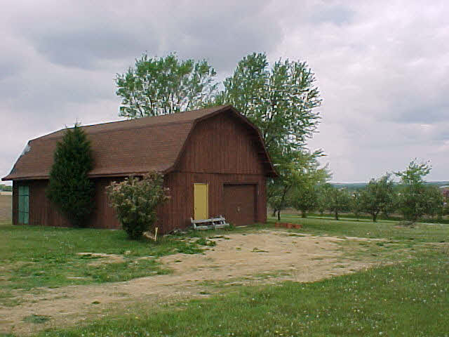 11311 Smith Road Pecatonica, IL 61063 - Photo 3 of 5 a front view of a house with a garden