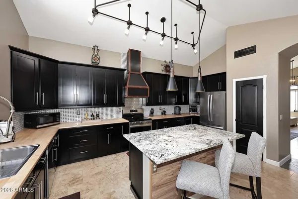a bathroom with a granite countertop tub sink a mirror and a bathtub