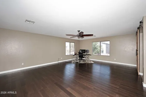 a view of empty room with wooden floor and fireplace
