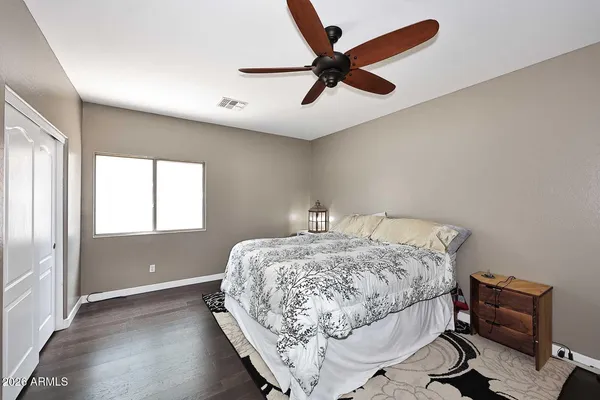 a bedroom with a bed and a chair