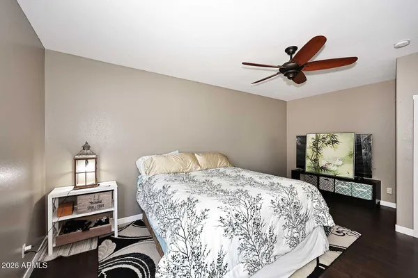 a bedroom with a bed and a tv