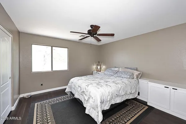 a bed sitting in a bedroom next to a window
