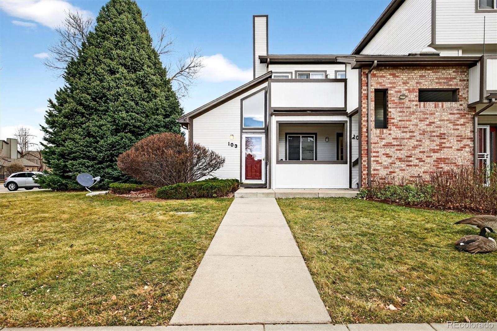 5021 Garrison Street, Unit 103A Wheat Ridge, CO 80033 - Photo 1 of 19 a house view with a outdoor space
