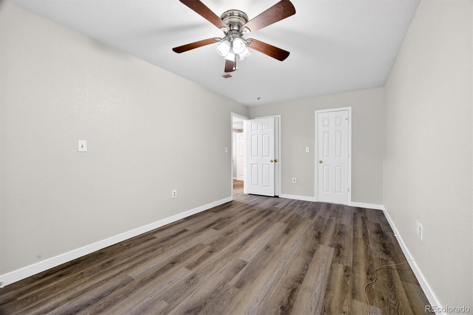 5021 Garrison Street, Unit 103A Wheat Ridge, CO 80033 - Photo 11 of 19 wooden floor in an empty room