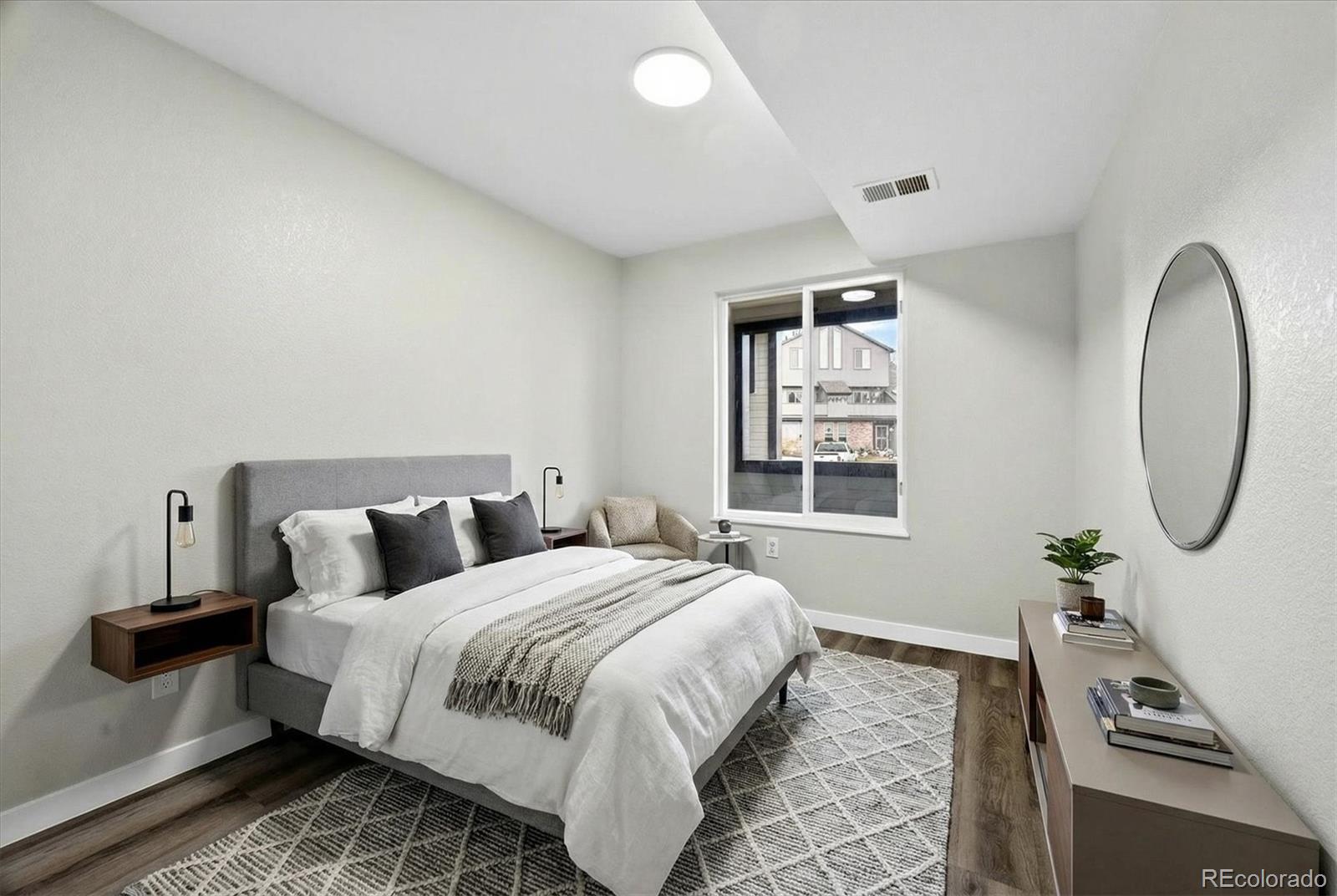 5021 Garrison Street, Unit 103A Wheat Ridge, CO 80033 - Photo 15 of 19 a bedroom with bed and a window