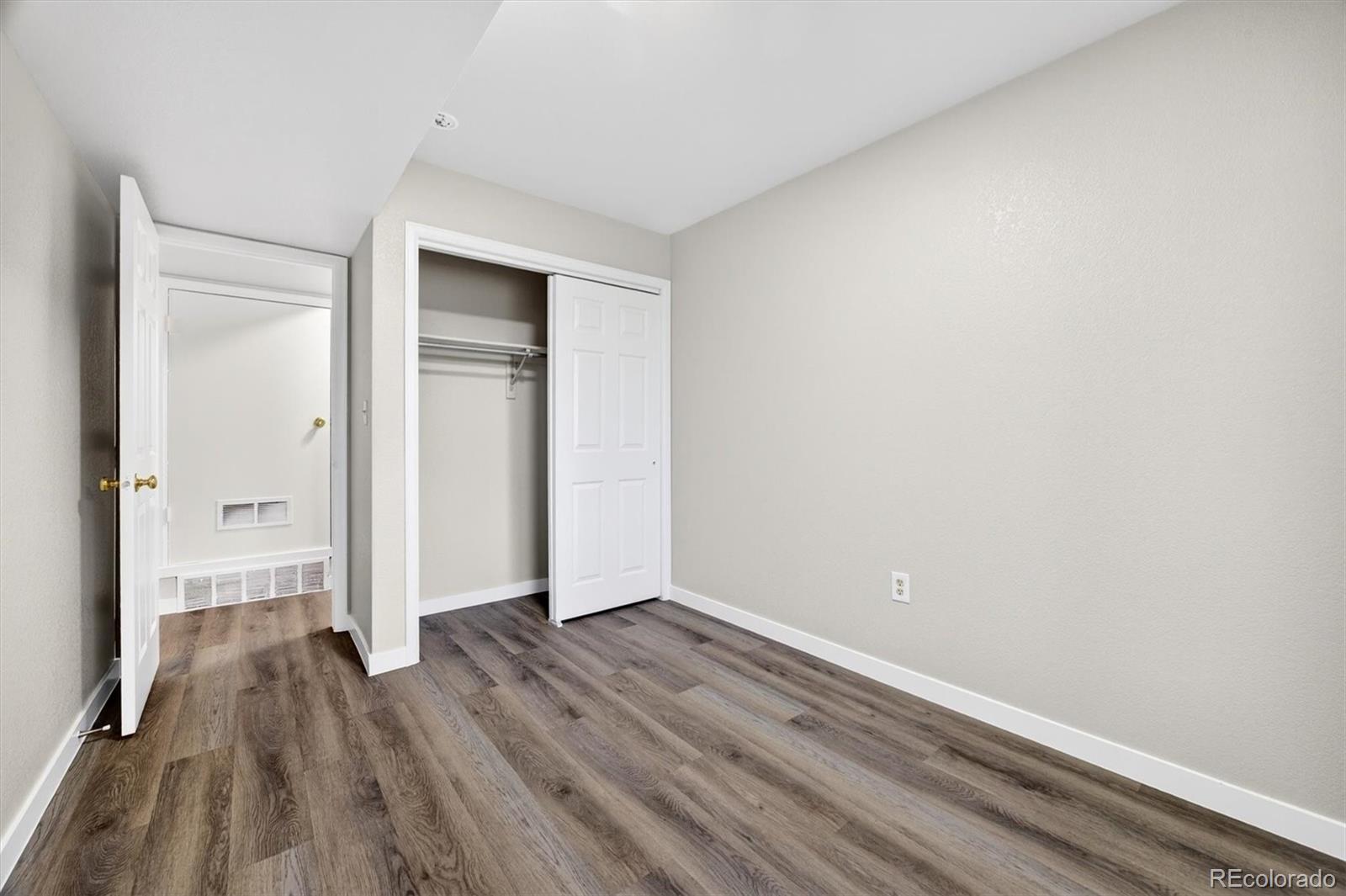 5021 Garrison Street, Unit 103A Wheat Ridge, CO 80033 - Photo 16 of 19 a view of a room with wooden floor