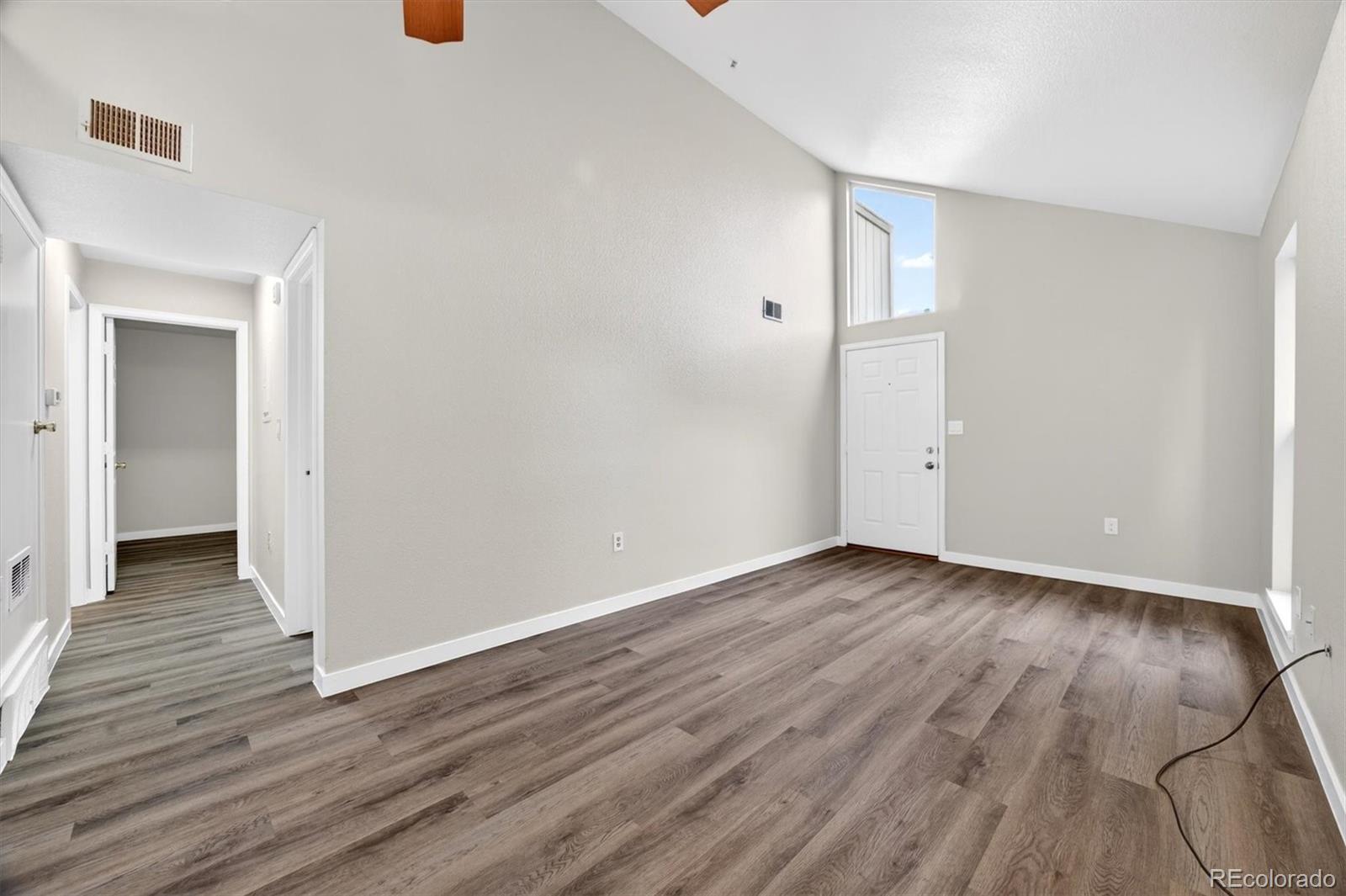 5021 Garrison Street, Unit 103A Wheat Ridge, CO 80033 - Photo 6 of 19 a view of an empty room with wooden floor