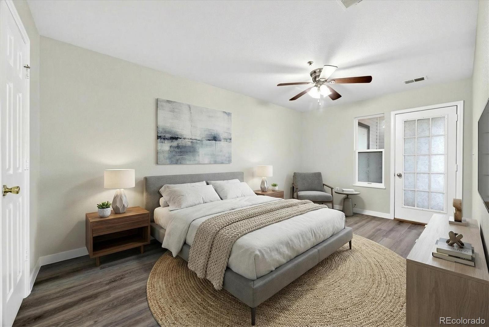 5021 Garrison Street, Unit 103A Wheat Ridge, CO 80033 - Photo 9 of 19 a bedroom with a bed furniture and a window