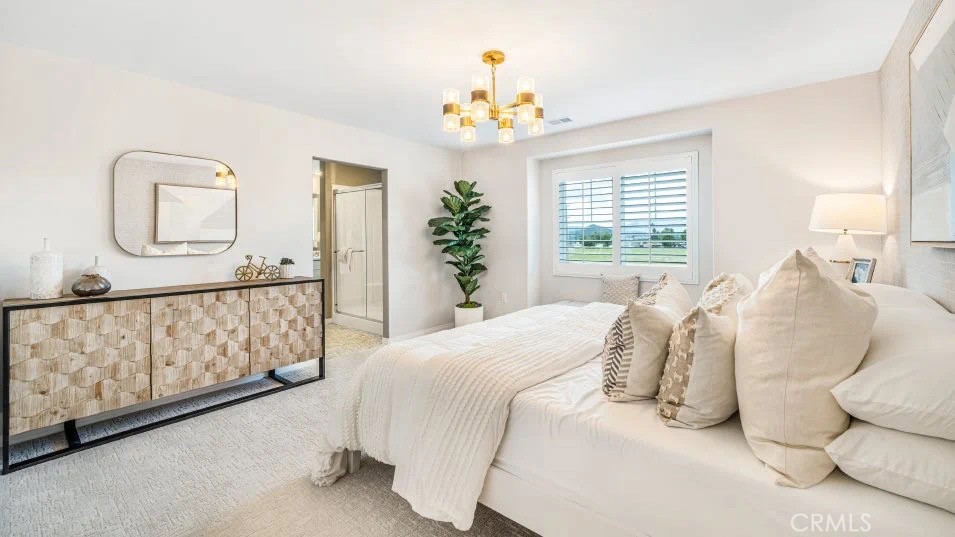 7498 Olive Grv Street Riverside, CA 92507 - Photo 5 of 14 a bedroom with a large bed and a chandelier