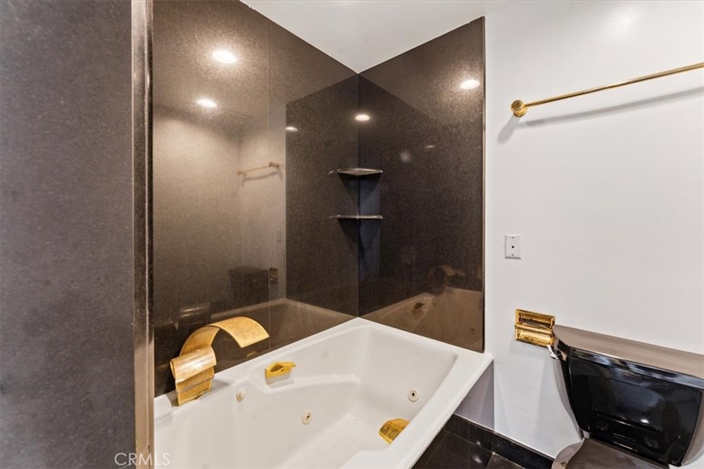 10501 Wilshire Boulevard, Unit 1103 Los Angeles, CA 90024 - Photo 18 of 34 a bathroom with a tub and a shower