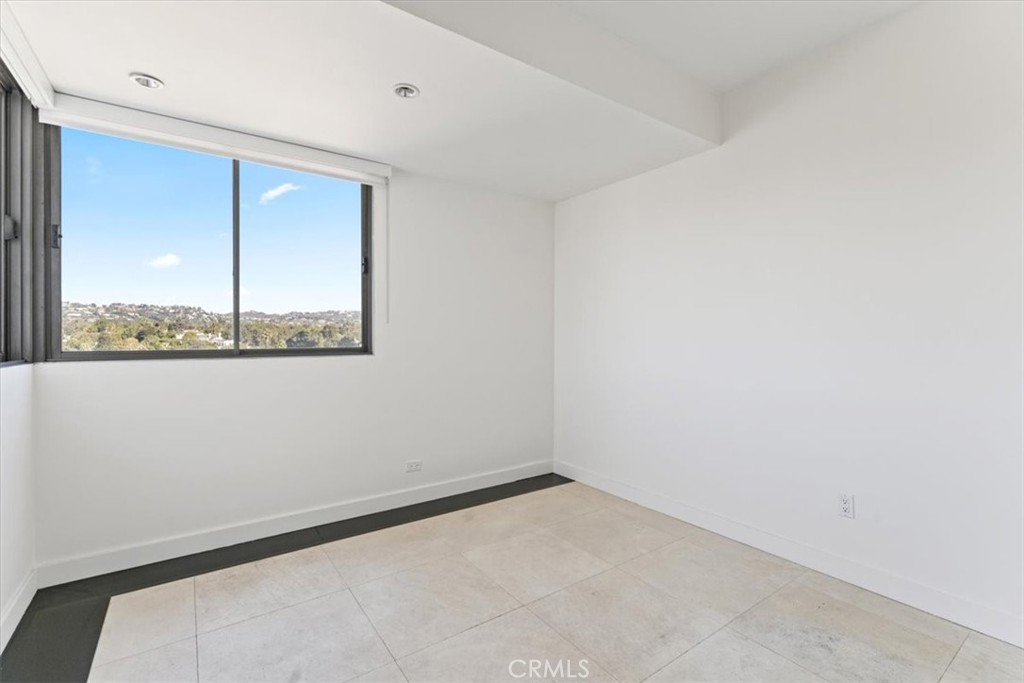 10501 Wilshire Boulevard, Unit 1103 Los Angeles, CA 90024 - Photo 21 of 34 a view of an empty room with a window