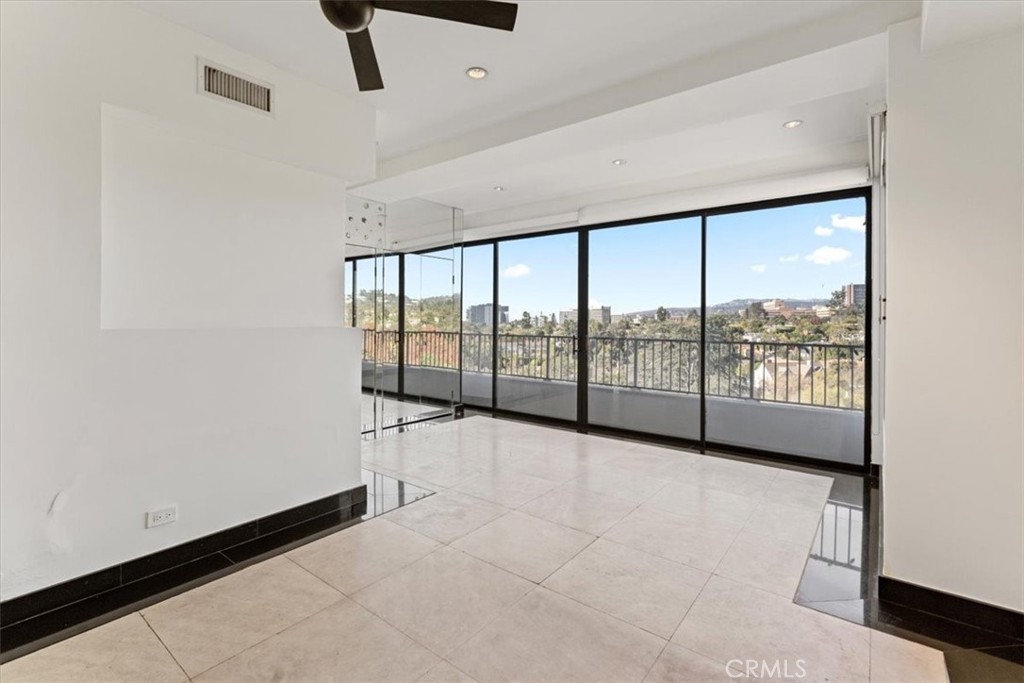 10501 Wilshire Boulevard, Unit 1103 Los Angeles, CA 90024 - Photo 25 of 34 a view of an empty room with windows