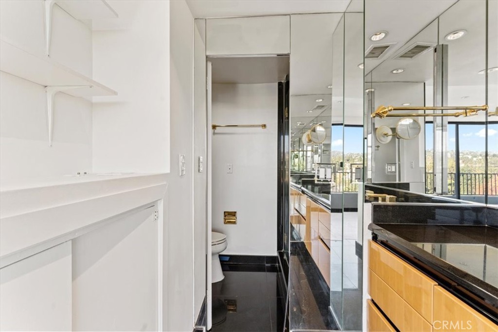 10501 Wilshire Boulevard, Unit 1103 Los Angeles, CA 90024 - Photo 27 of 34 a kitchen with stainless steel appliances a sink and a refrigerator