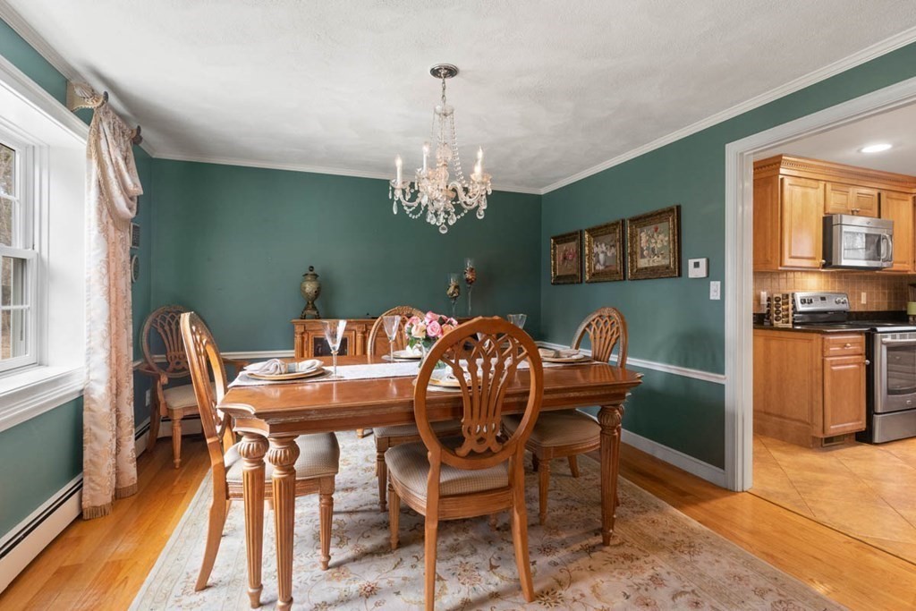 2 Tanglewood Road Boxford, MA 01921 - Photo 11 of 35 a view of a dining room with furniture a chandelier and wooden floor