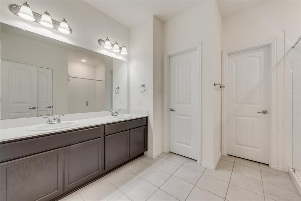 4517 Raleigh Dalton Road Dallas, TX 75227 - Photo 12 of 20 a spacious bathroom with a double vanity sink a mirror and a shower