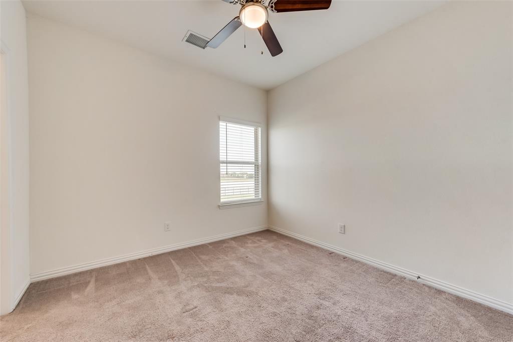 4517 Raleigh Dalton Road Dallas, TX 75227 - Photo 15 of 20 an empty room with a window and a ceiling fan