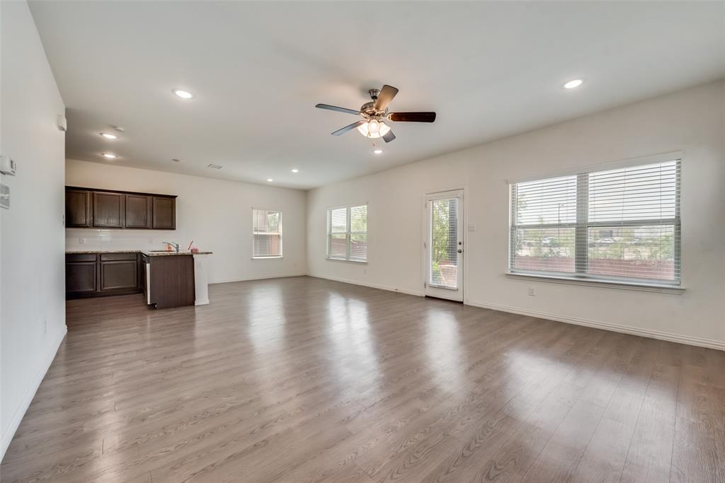 4517 Raleigh Dalton Road Dallas, TX 75227 - Photo 4 of 20 a view of an empty room with window and wooden floor