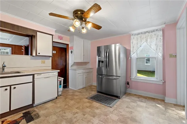 a kitchen with stainless steel appliances granite countertop a refrigerator a stove a sink and a refrigerator with wooden floor