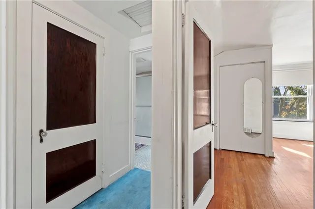 a view of hallway with fireplace and wooden floor