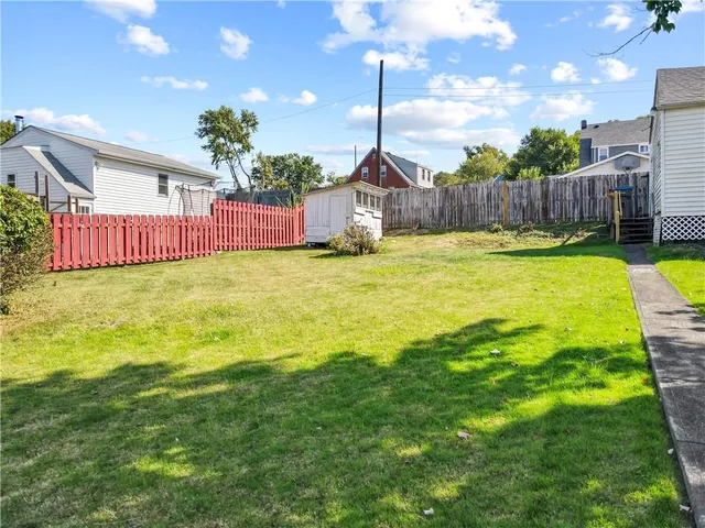 a swimming pool with yard and outdoor seating