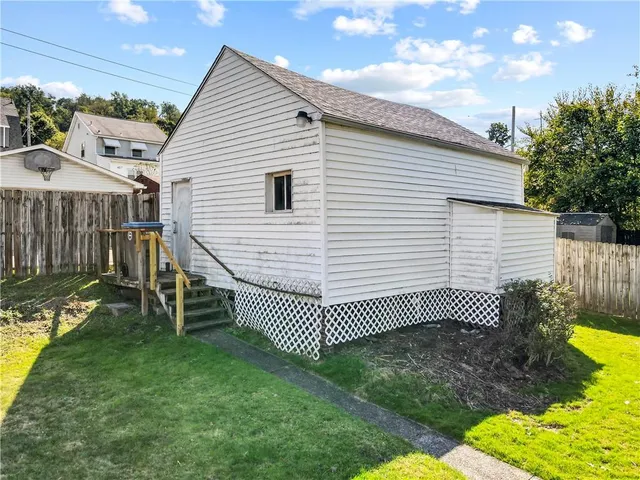 a view of a white house with a yard