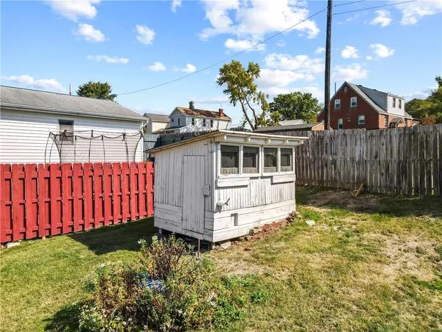 a view of a house with wooden fence