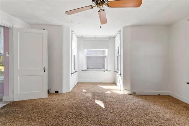 an empty room with a empty space and windows