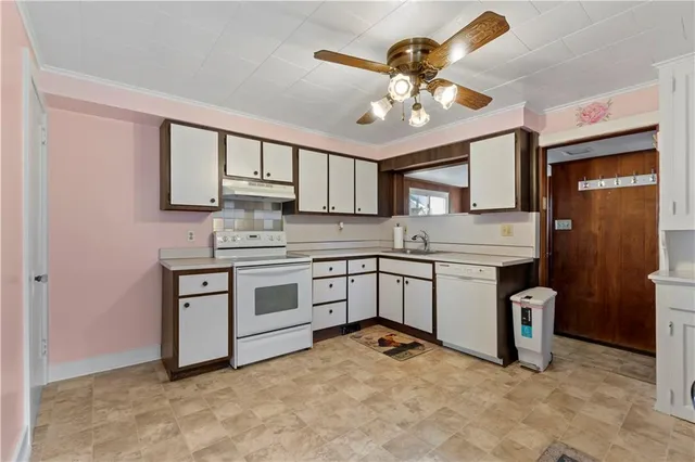 a kitchen with stainless steel appliances granite countertop a stove sink and cabinets