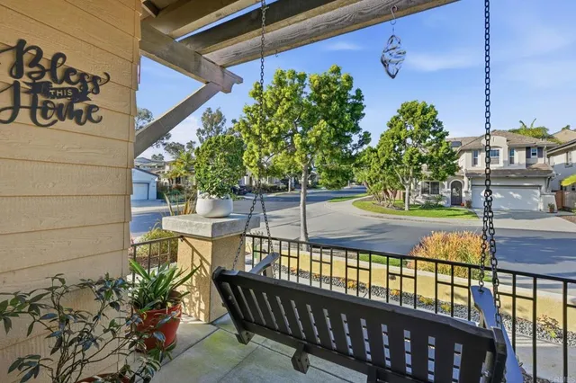 a view of a porch with a floor to ceiling window next to a yard