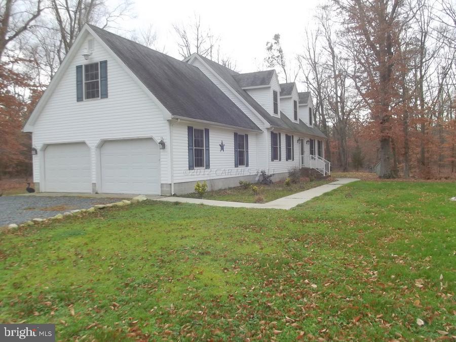 10665 Clarence Barnes Road Princess Anne, MD 21853 - Photo 8 of 21 a view of a house with a yard and garage