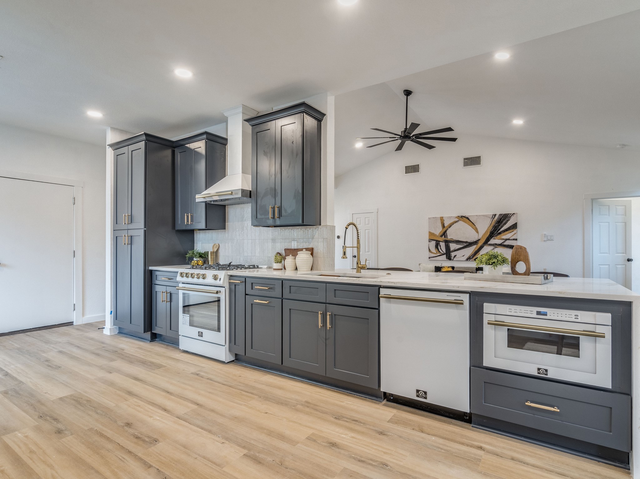 a kitchen with stainless steel appliances granite countertop a sink a stove and a refrigerator