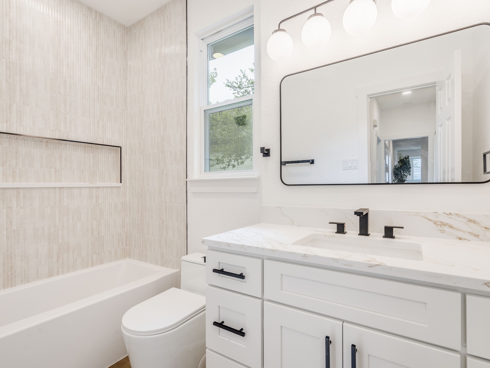 11810 Bittern Hollow Austin, TX 78758 - Photo 15 of 22 a bathroom with a toilet a sink a mirror a bathtub and vanity