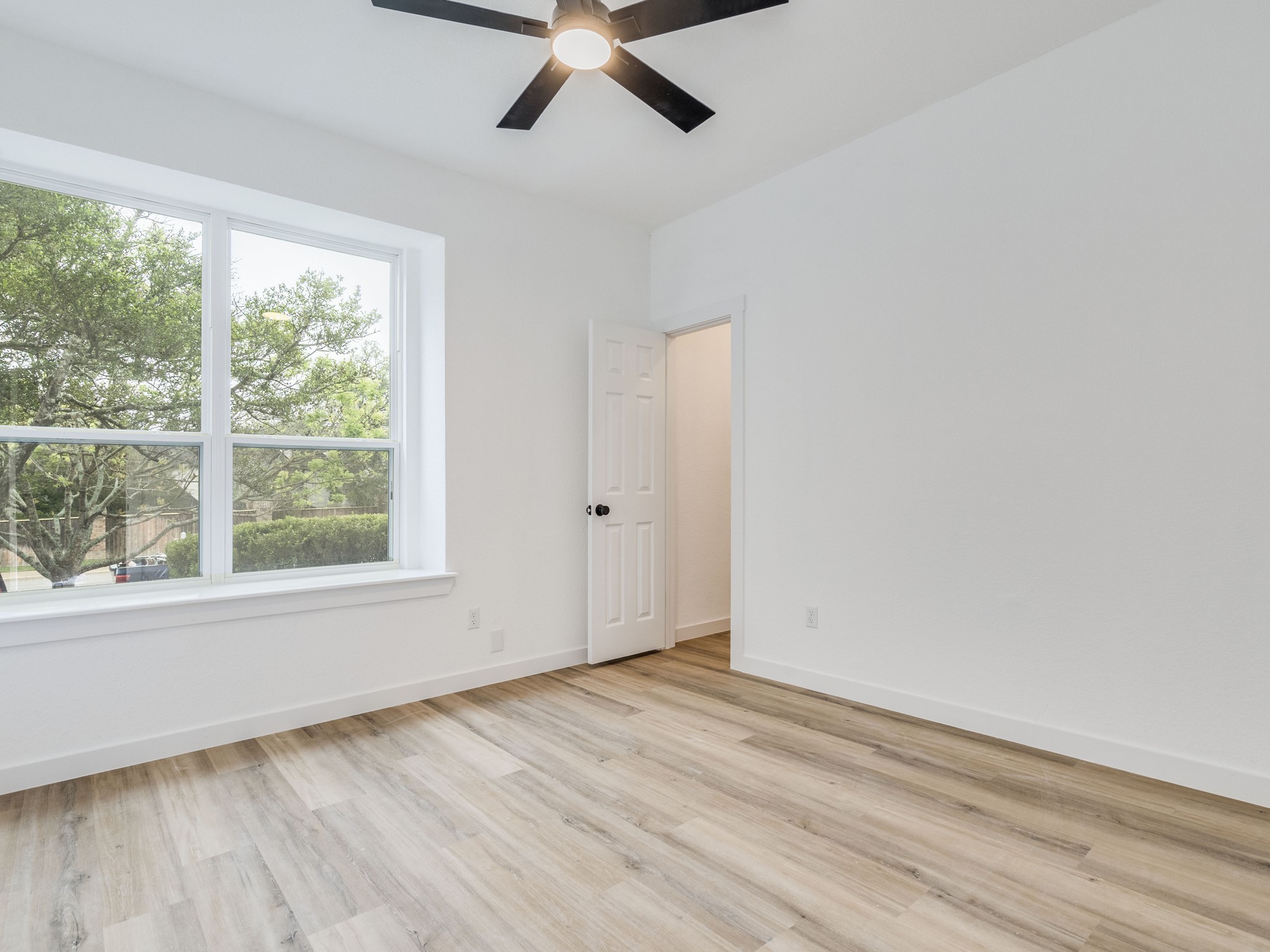 11810 Bittern Hollow Austin, TX 78758 - Photo 16 of 22 an empty room with wooden floor and windows