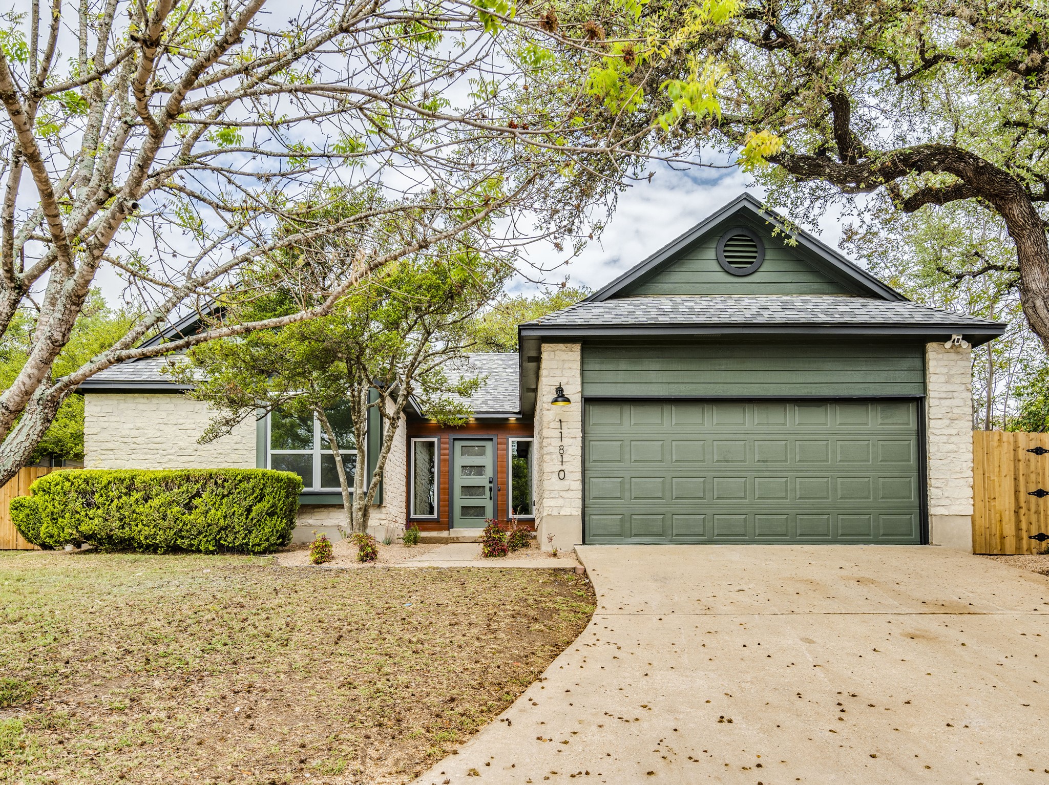 11810 Bittern Hollow Austin, TX 78758 - Photo 2 of 22 a front view of a house with a yard and garage