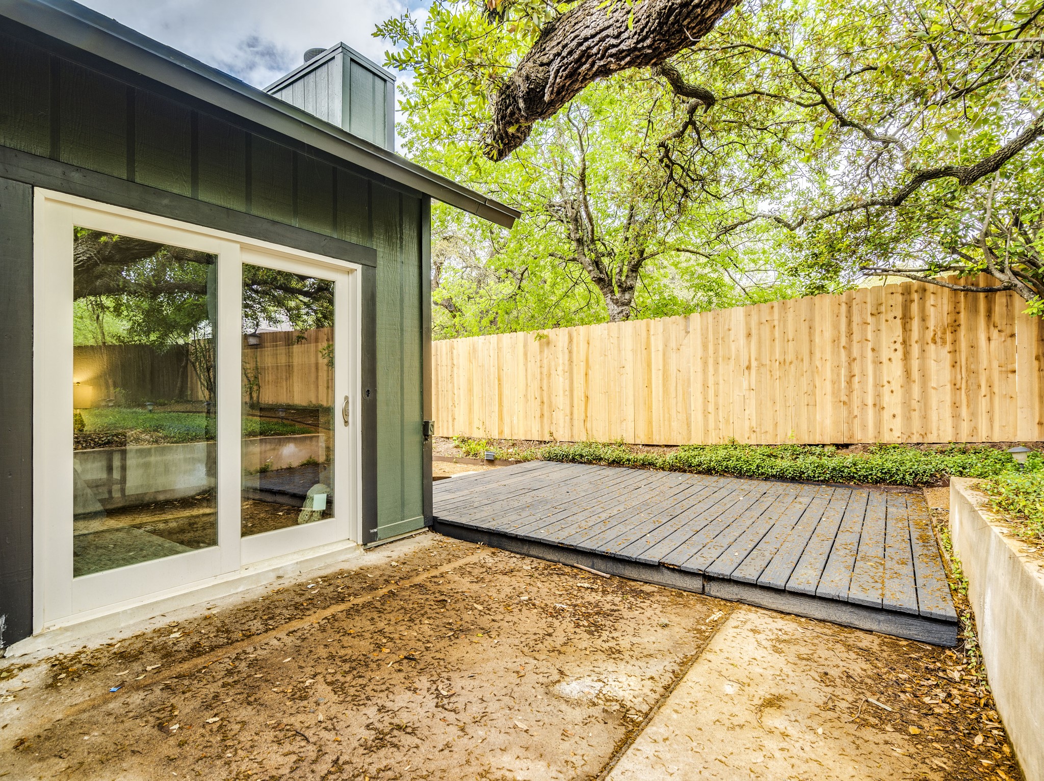 11810 Bittern Hollow Austin, TX 78758 - Photo 10 of 22 a view of a backyard with wooden floor and large tree